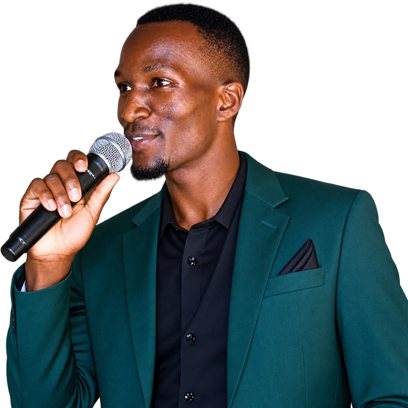 Maxwell Changilwa speaking into a microphone at a community meeting