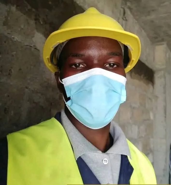 Construction worker in a yellow helmet and high-visibility vest